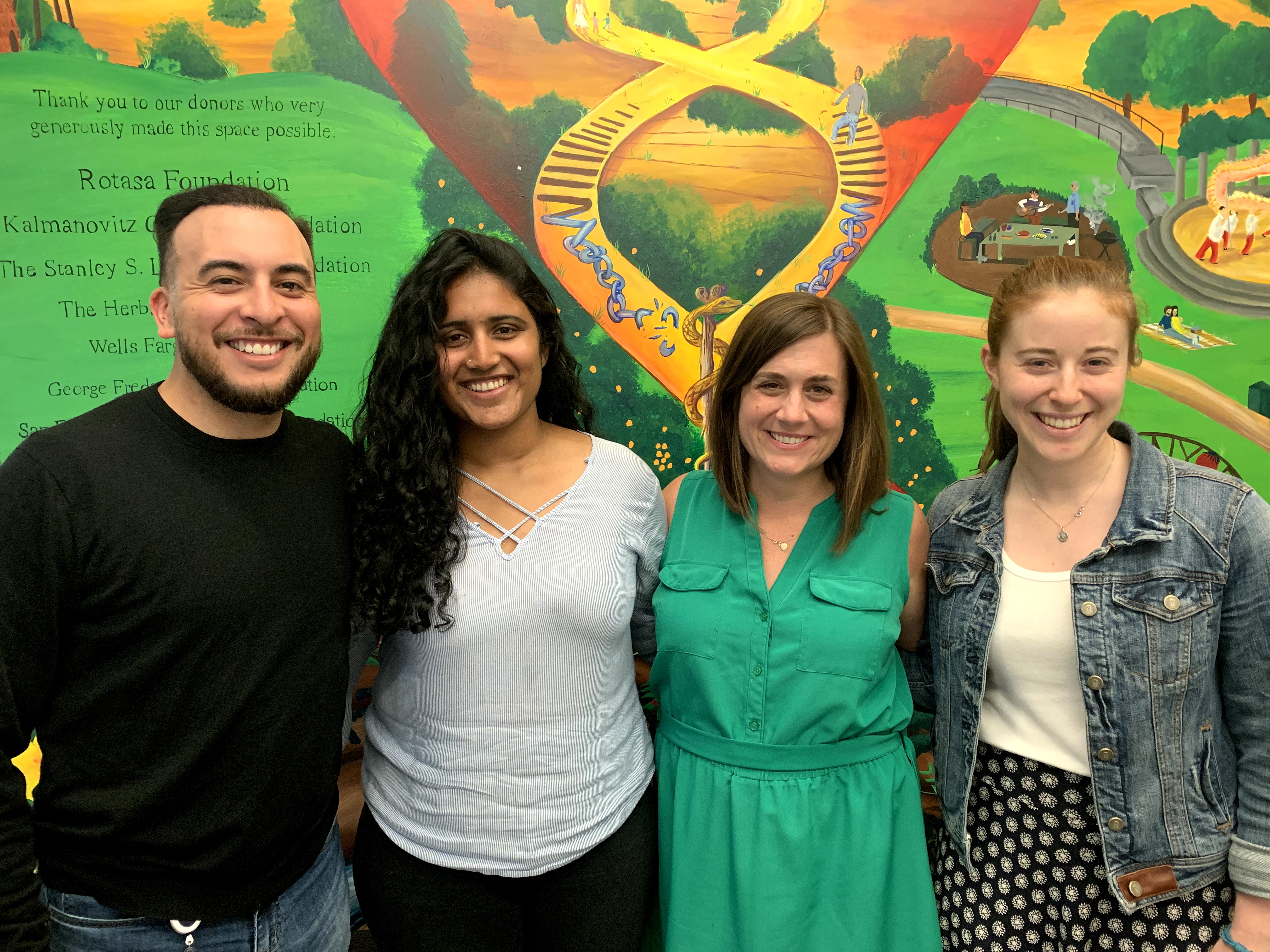 Group photo of Lyles Lab members - Courtney Lyles, Jose Miramontes, Anupama Cemballi, and Jessica Fields - in front of the CVP Mural.